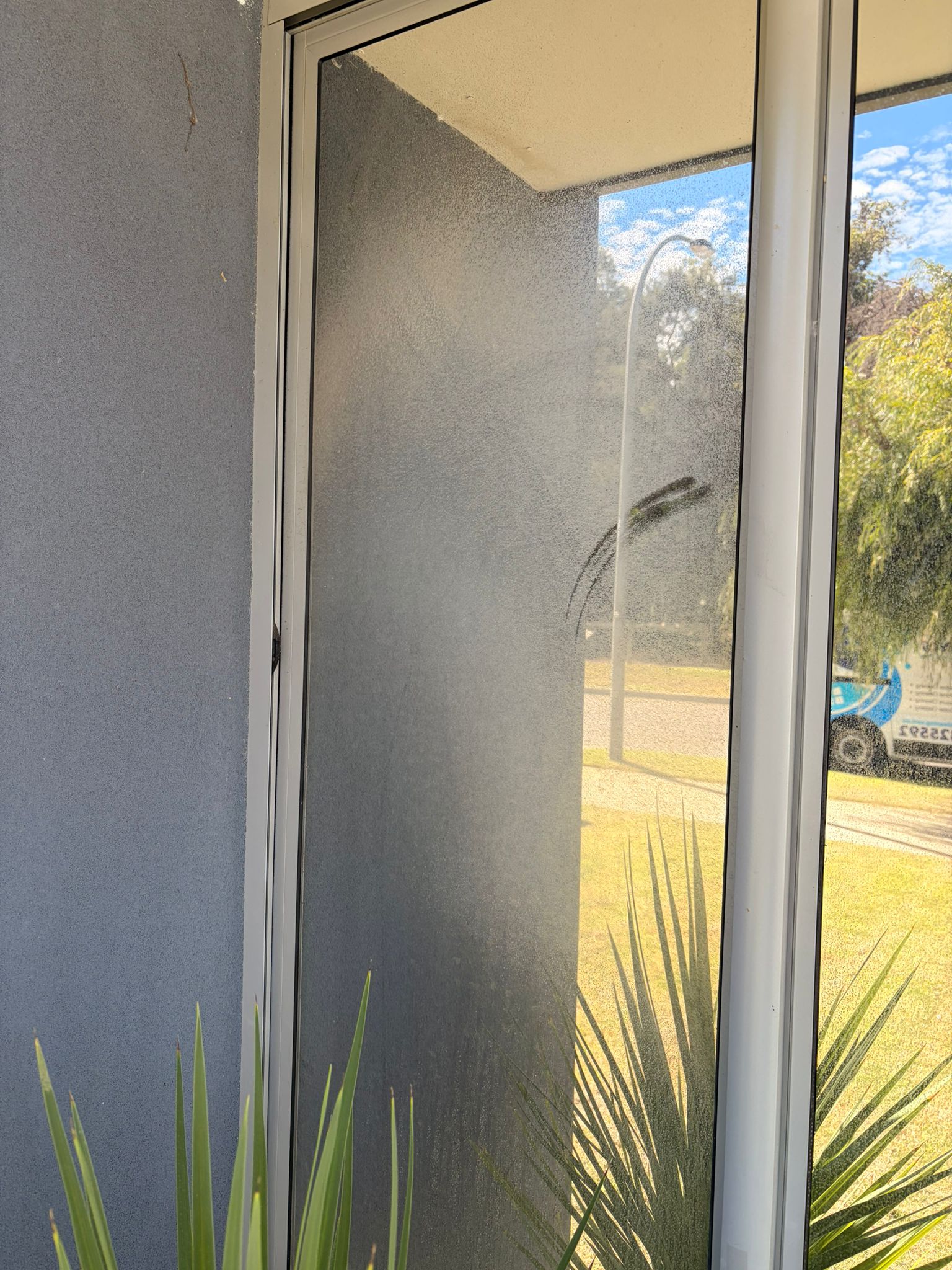 Before window cleaning Cooloongup - corner window panels covered in mineral haze and fine dust accumulation