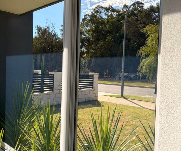 After window cleaning Cooloongup - crystal clear corner windows showing street, trees and blue sky