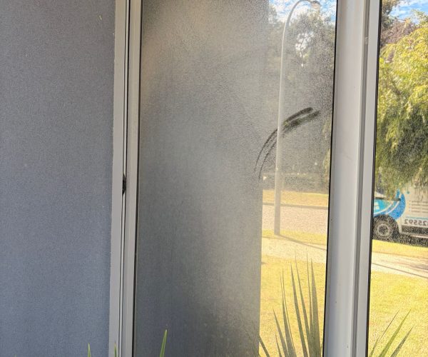 Before window cleaning Cooloongup - corner window panels covered in mineral haze and fine dust accumulation